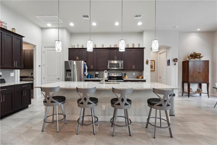 Door to left of fridge is pantry & hallway to right of kitchen leads to guest rooms.