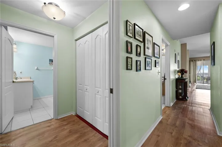 Hallway to kitchen and living room, to the left is the laundry room and second bathroom