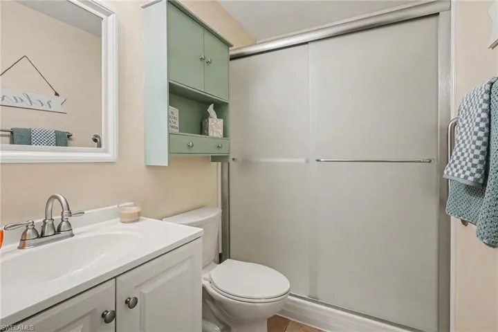 Full bathroom featuring vanity and a shower stall