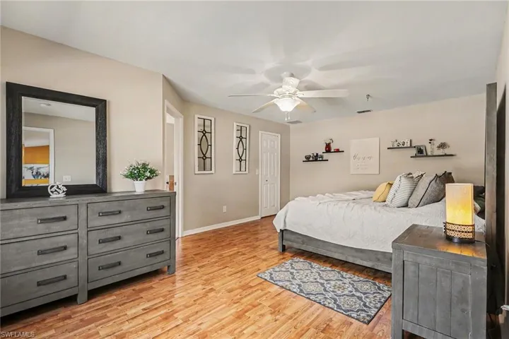 Bedroom with light wood finished floors and ceiling fan