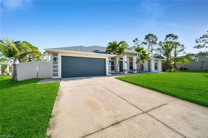 View of front of home with concrete v driveway, an attached garage, and stucco siding
