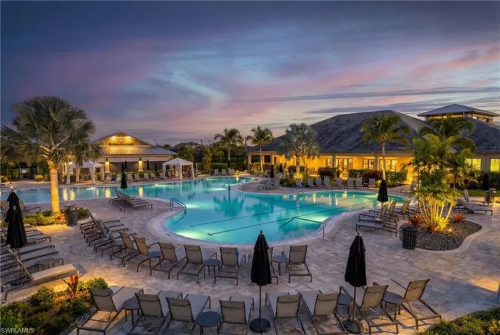 Pool at dusk with a community pool and a patio