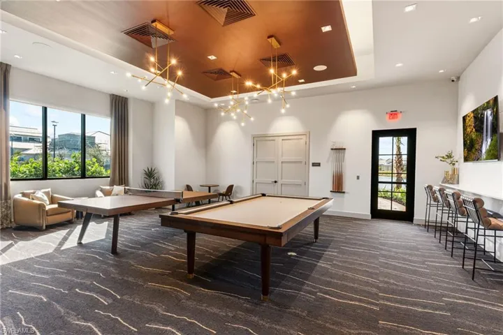 Playroom featuring billiards, a tray ceiling, and recessed lighting