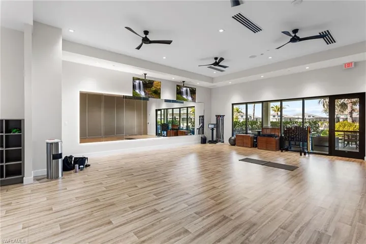 Workout area with a high ceiling, recessed lighting, and a ceiling fan