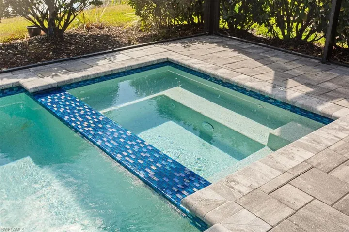 View of pool featuring an in-ground hot tub and patio surround