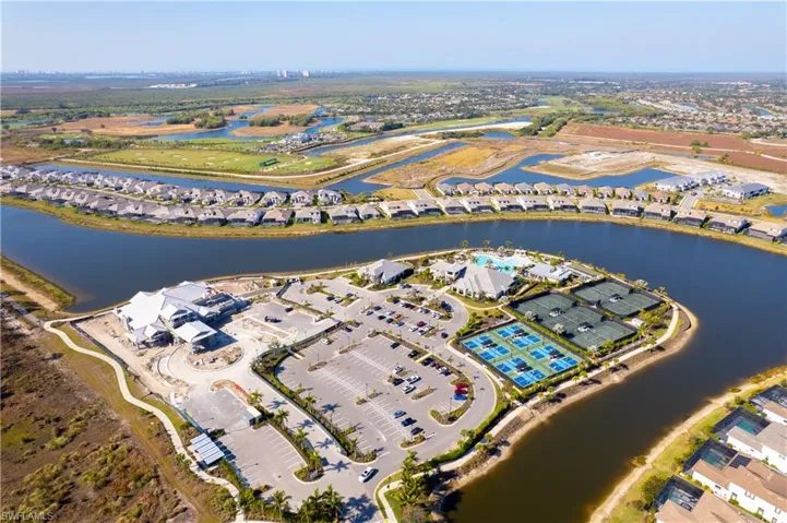 Aerial overview of property's location with nearby suburban area and a nearby body of water