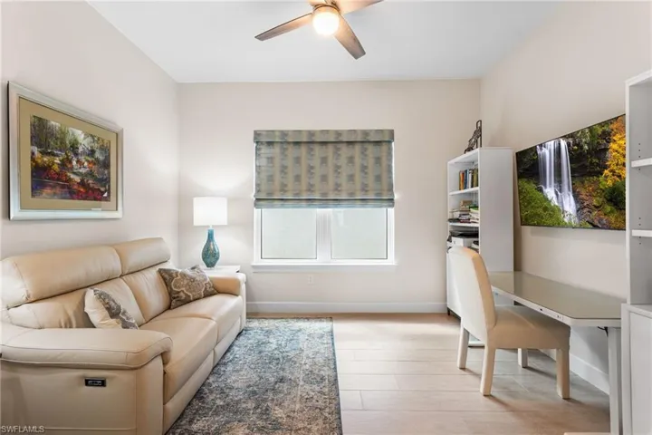 Living room featuring ceiling fan, a desk, and light wood finished floors
