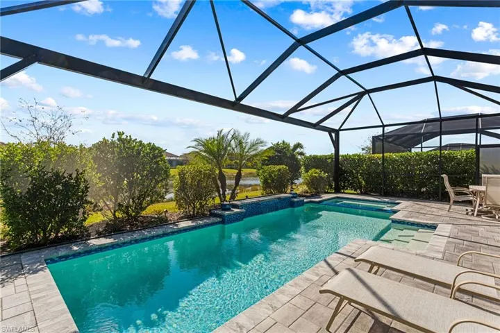 Integrated pool / spa with a lanai, a sunroom, and a patio area