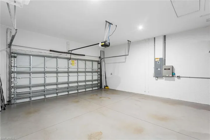 Garage with electric panel and a garage door opener