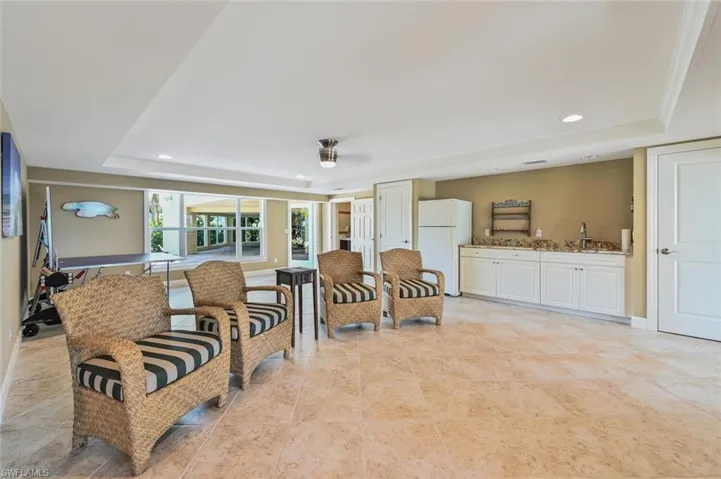 Living room featuring indoor wet bar and a tray ceiling