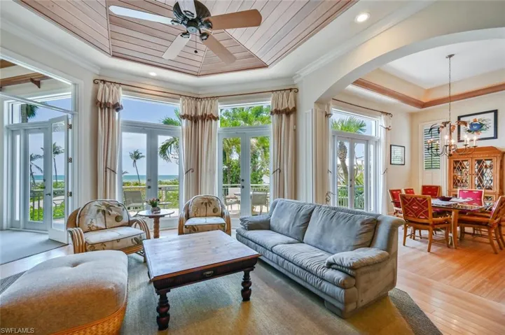 Sunroom / solarium with french doors, a tray ceiling, plenty of natural light, and wood ceiling