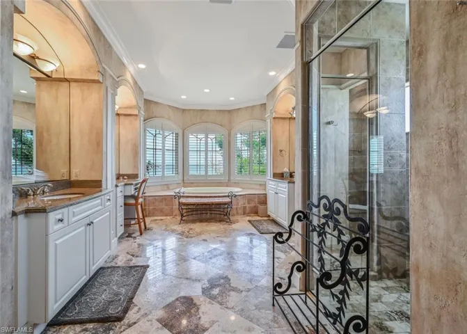 Bedroom featuring ornamental molding, access to exterior, light colored carpet, and a fireplace