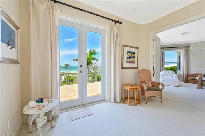 Sitting room featuring a water view, crown molding, carpet floors, and french doors