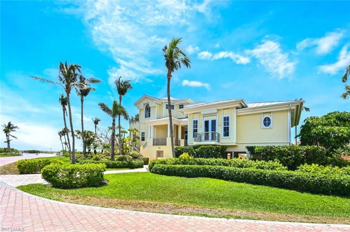 doors, a front lawn, and a balcony