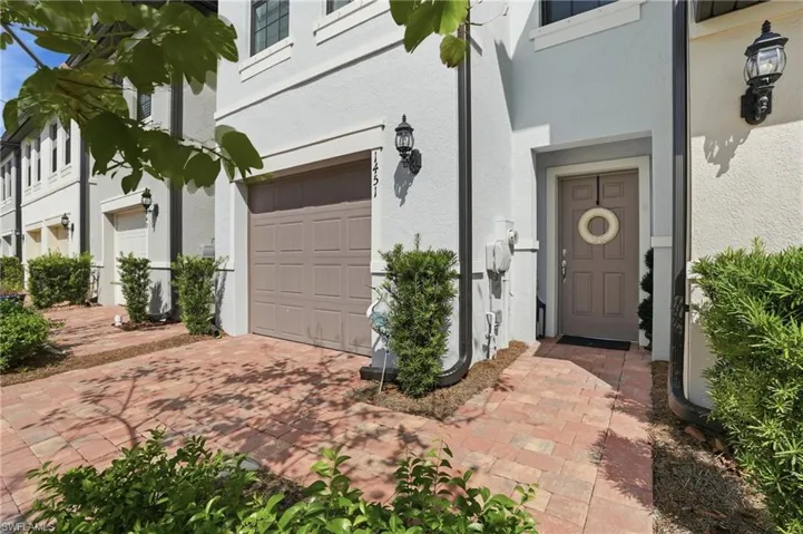 Exterior features a painted stucco finish with a contrasting entry
