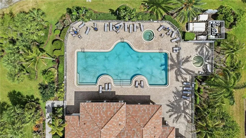 Expansive amenity area featuring a freeform swimming pool, two integrated spas, and extensive paver decking