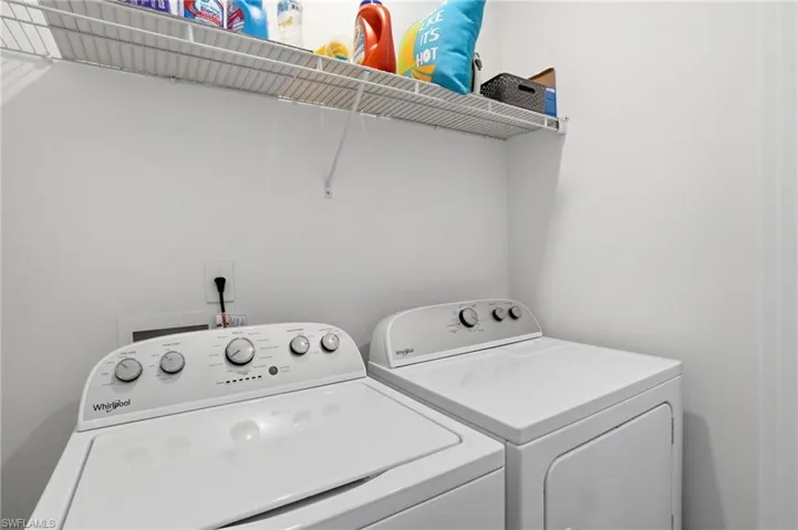 Dedicated laundry area on second floor featuring a white wire shelving unit