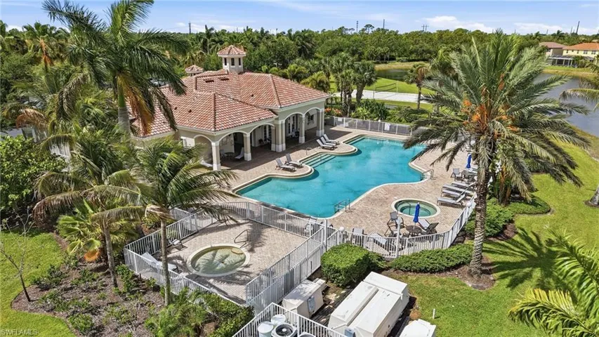 Resort-style pool area featuring a freeform swimming pool, integrated spa, and two additional standalone spas