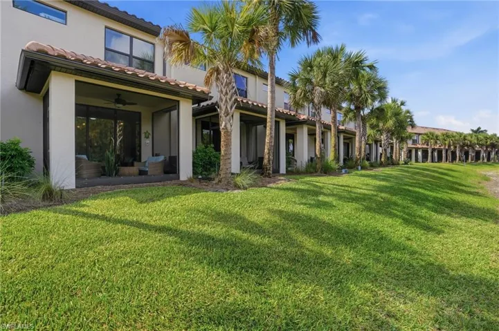 Expansive green space featuring a row of palm trees