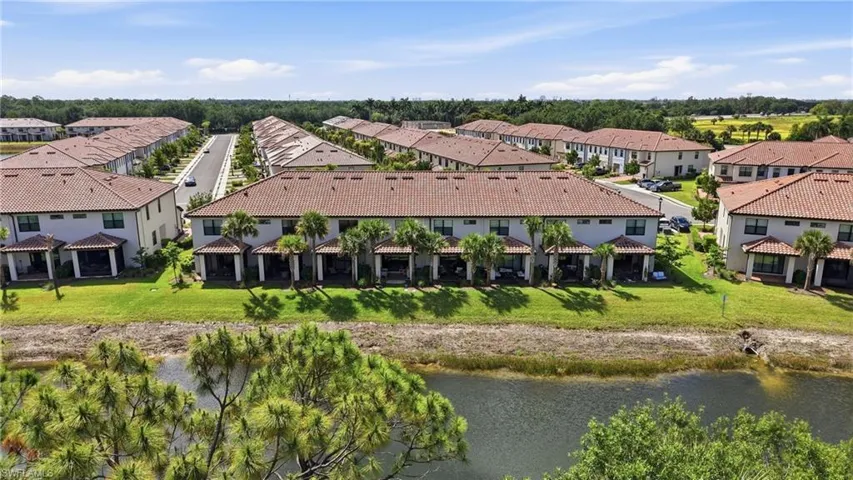 Townhome community featuring terra cotta tile roofs and light-colored exteriors