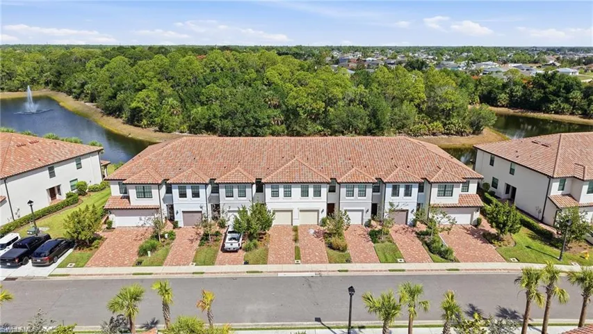 Townhome community featuring Mediterranean-inspired architecture with terracotta-style roofs and light-toned stucco exteriors