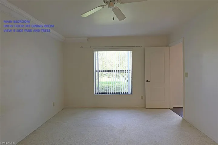 MAIN BEDROOM --- ENTRY DOOR TO DINING ROOM --- WINDOW TO THE SIDE YARD AND TREES
