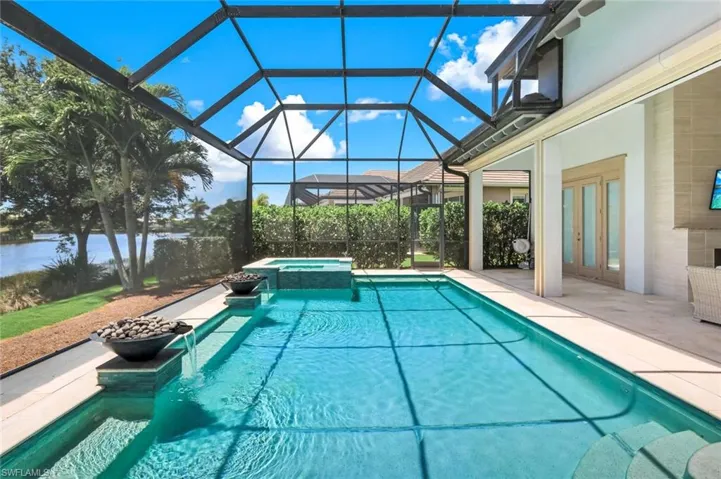 Peaceful pool setting featuring water and fire bowls