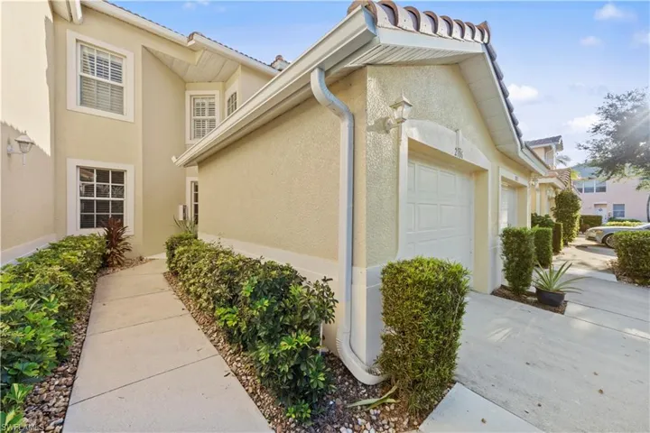 View of side of property featuring stucco siding and an attached garage