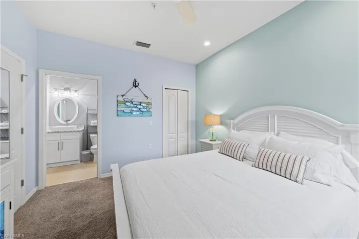 Bathroom with double vanity, a stall shower, and light tile patterned flooring