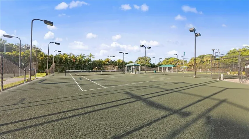 View of tennis court with community basketball court