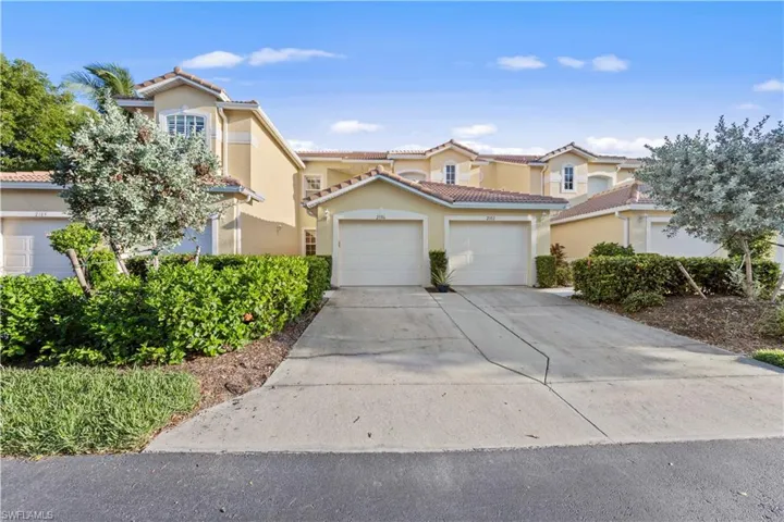 Mediterranean / spanish-style house with concrete driveway, stucco siding, a tiled roof, and an attached garage