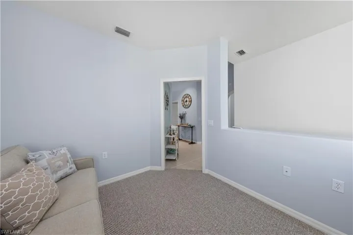 Sitting room featuring baseboards and carpet floors