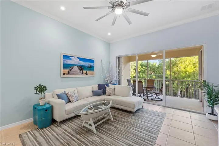 Living area featuring light tile patterned flooring, ornamental molding, recessed lighting, and a ceiling fan