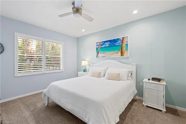 Bedroom with carpet floors, ceiling fan, and recessed lighting