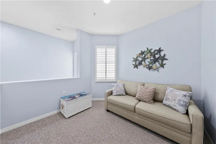 Living area featuring baseboards and carpet