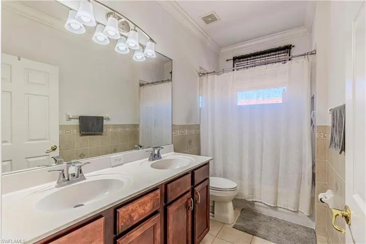 Bathroom featuring a sink, tile walls, and tile patterned floors