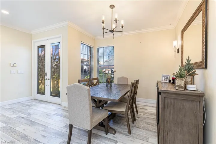 Dining room featuring french doors and crown molding