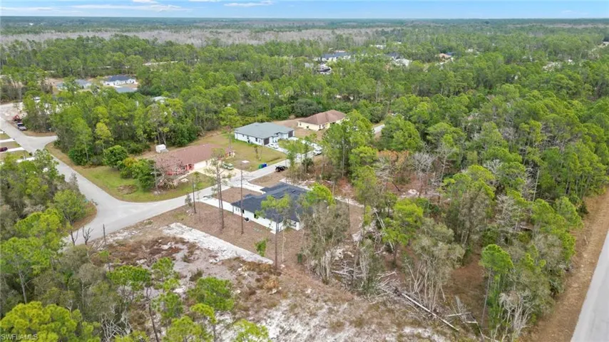 Aerial overview of property's location featuring a heavily wooded area