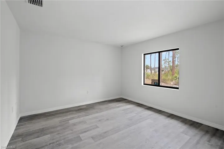 Spare room with light wood-style floors and baseboards