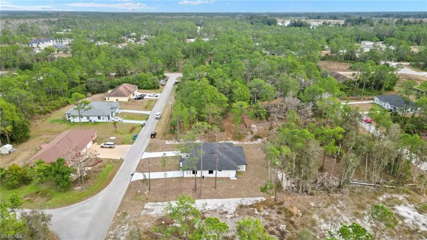 Aerial overview of property's location with a heavily wooded area