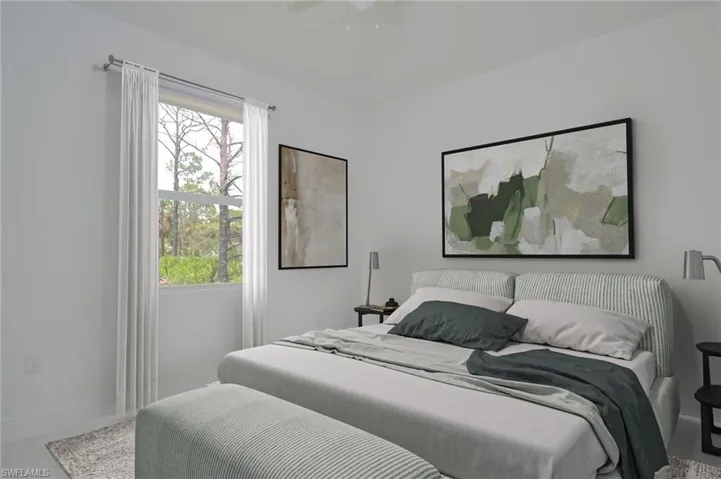 Bedroom with ceiling fan and tile patterned flooring
