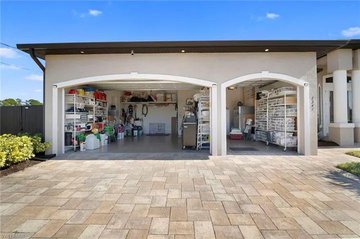 Garage featuring decorative driveway
