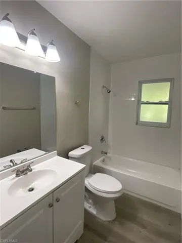 Full bathroom with vanity, and shower / tub combination