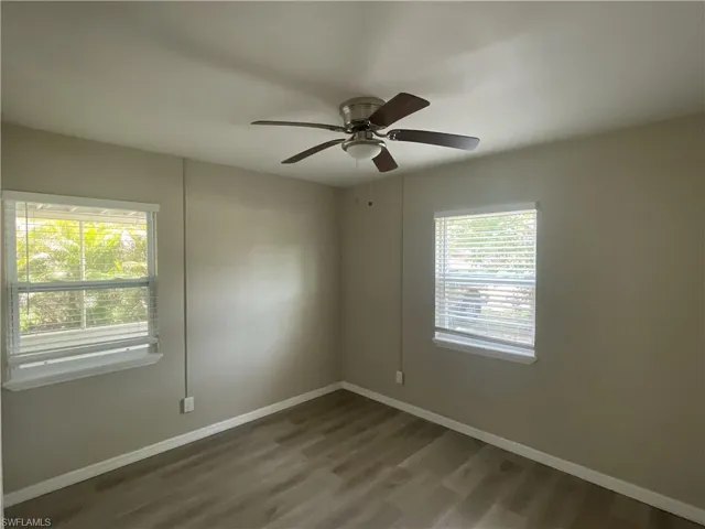 Unfurnished room featuring healthy amount of natural light, and ceiling fan