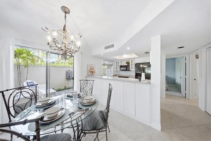 Dining area featuring light tile patterned floors and a chandelier