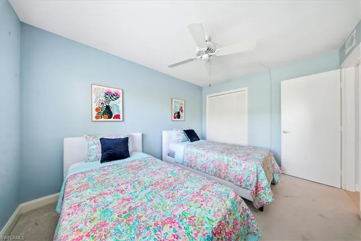 Bedroom featuring carpet flooring, a closet, and ceiling fan