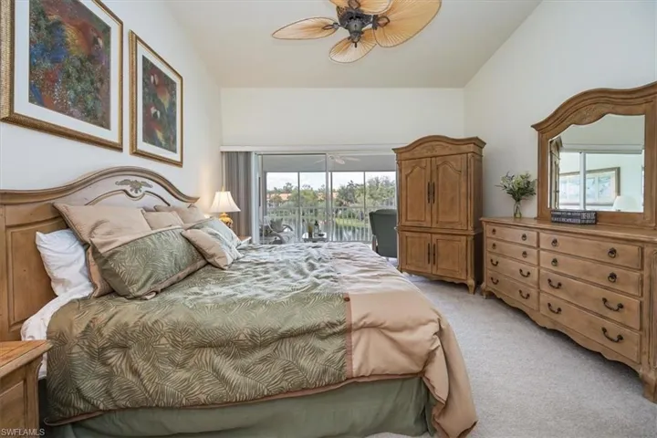 Bedroom with access to outside, light carpet, multiple windows, and ceiling fan