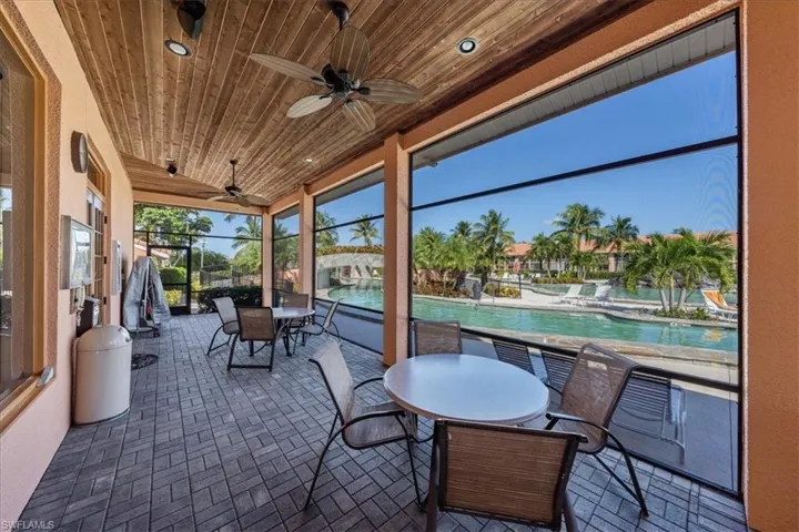 View of patio with ceiling fan and a community pool