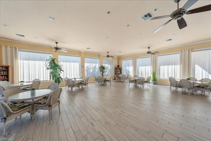 Dining area featuring light wood-type flooring, ceiling fan, and plenty of natural light