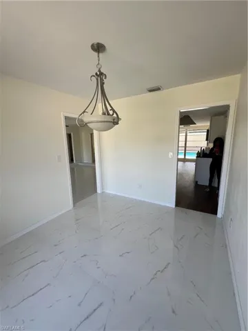Unfurnished room featuring marble finish floors